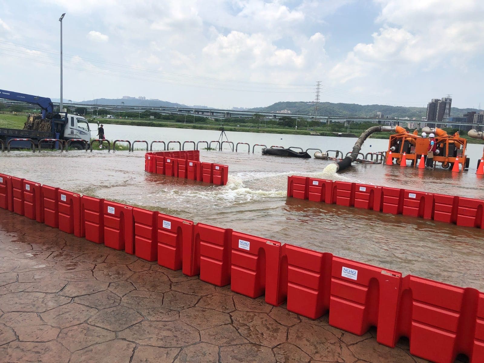 Mobile flood barrier deployment along a logistics corridor